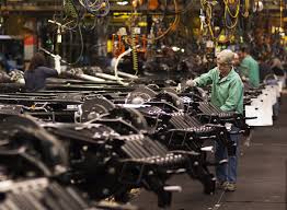 Workers on an automotive assembly line