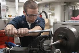 Machinist operating a lathe