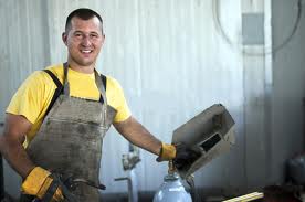Tradesman in work apron and gloves